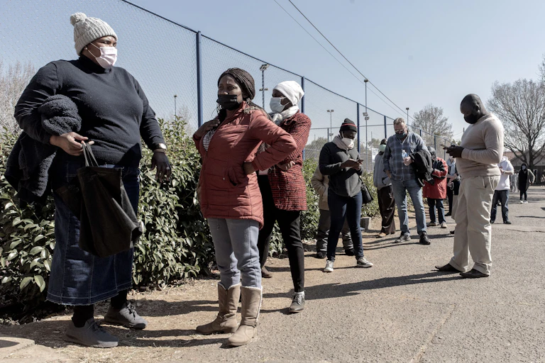 People wearing masks standing in a line