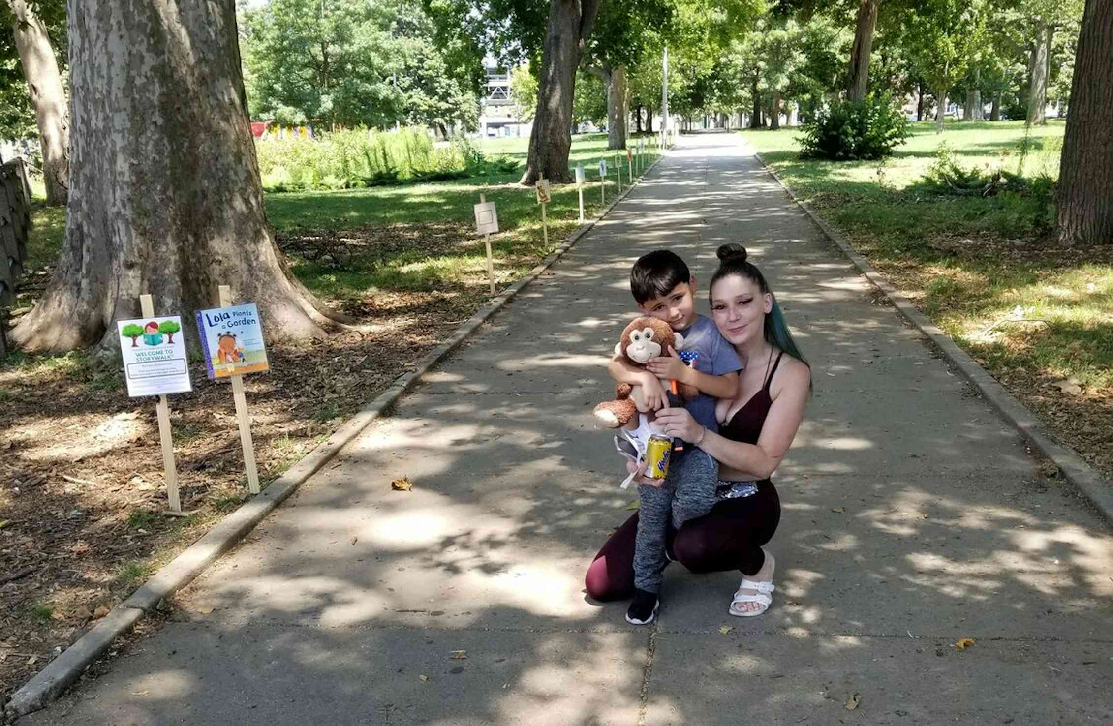 Mother and sun attend a StoryWalk in Philadelphia park