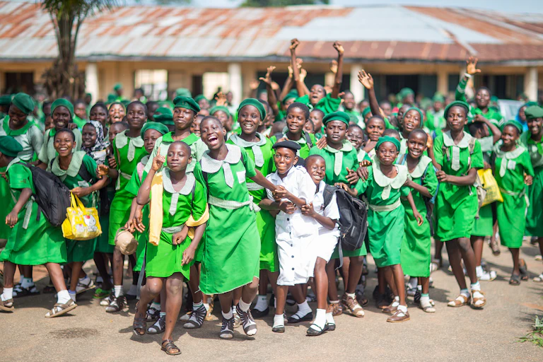 Students of the Islamic Girl's High School cheer during the arrival of German Minister of Economic Cooperation and Development, Gerd Mueller (CSU) near Abeokuta, Nigeria, 11 June 2014