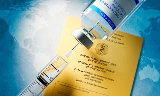 syringe, vial and vaccination certificate