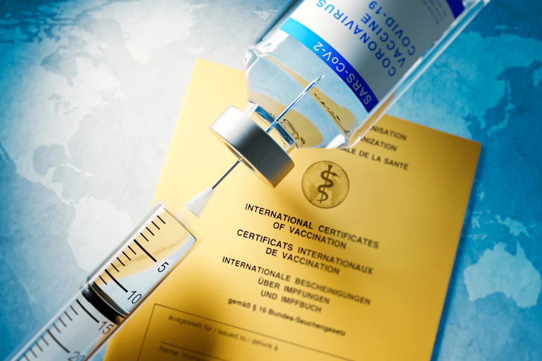 syringe, vial and vaccination certificate
