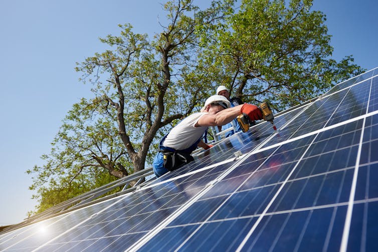 Person installing rooftop solar