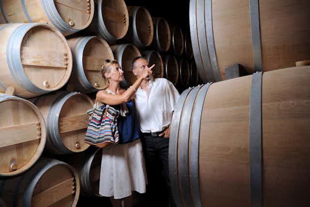 man and woman in wine cellar