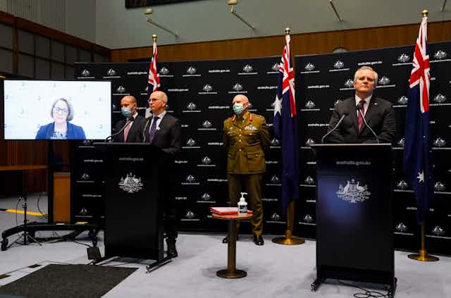 Jodie McVernon, appearing remotely at a press conference with Josh Frydenberg, Paul Kelly, General Frewen and Scott Morrison