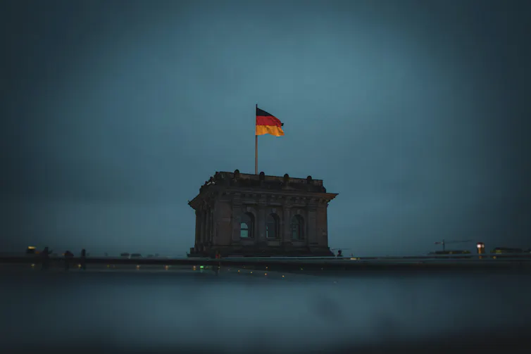 German flag on top of the Reinchstag at dusk