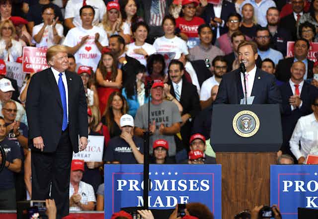 Trump and candidate Dean Heller, at a campaign rally with lots of people.