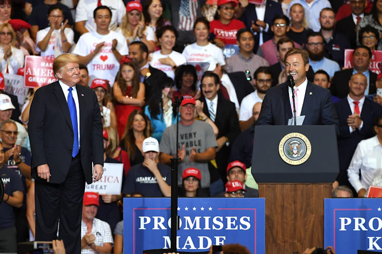 Trump and candidate Dean Heller, at a campaign rally with lots of people.