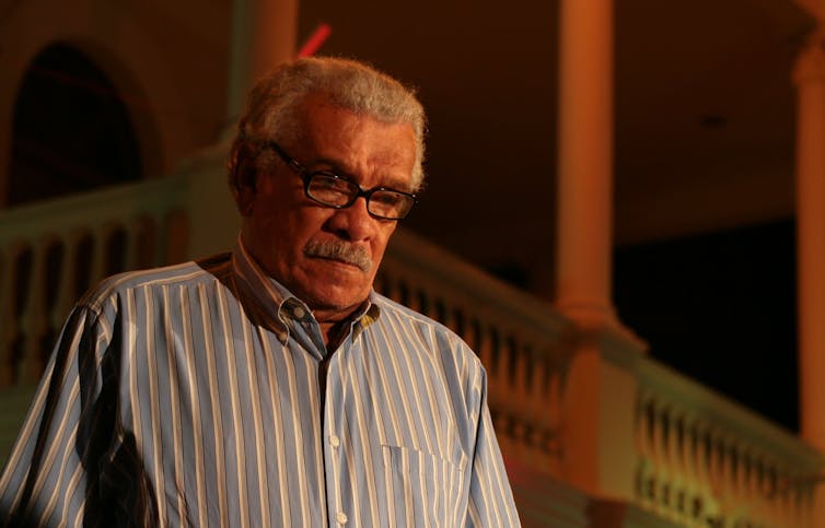 An older man wearing glasses