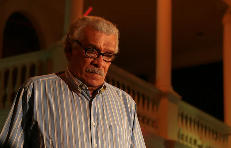 An older man wearing glasses