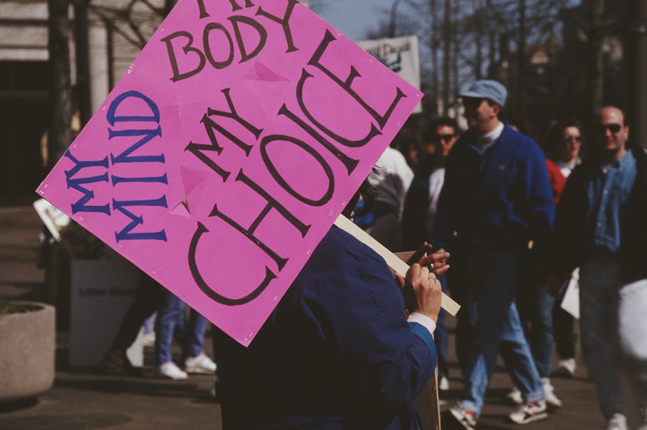 A protester holds a placard that reads 'My Mind, My Body, My Choice' at a 1992 pro-abortion rights rally.