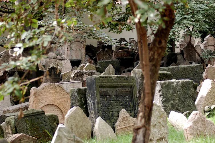 Graves crowd together in a cemetery
