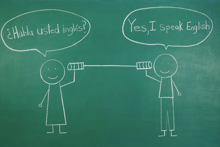 Two stick figures speak through a tin can in Spanish and English