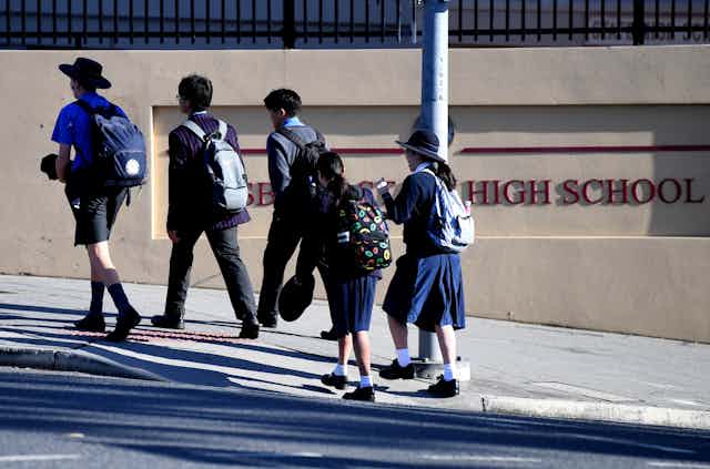 Children arrive at a high school in Brisbane