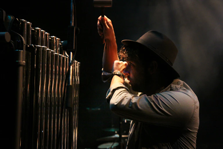 A man plays tubular bells