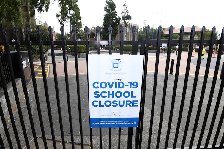 Sign announcing a COVID-19 school closure on school gates