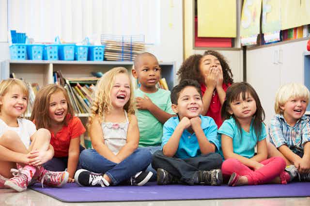 5-year-old children sitting on mat at school