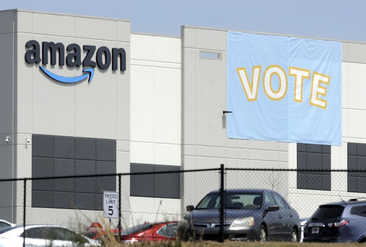 A banner outside an Amazon facility encourages workers to vote for unionization.