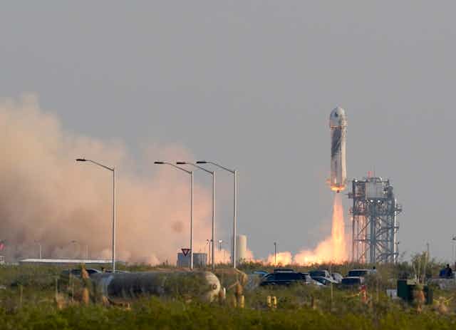 A rocket taking off from a launchpad. 