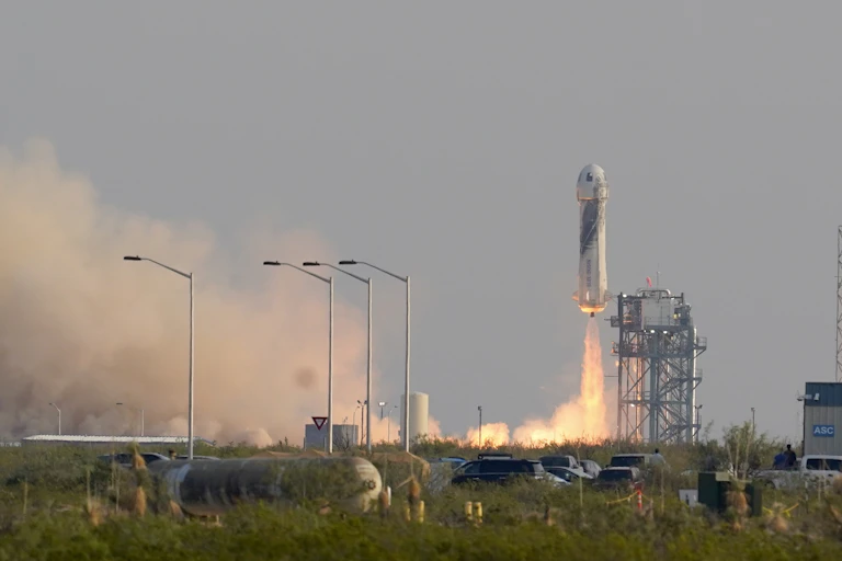 A rocket taking off from a launchpad.