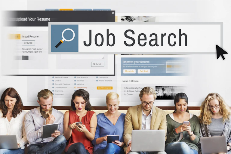Seven people sitting side by side completing job applications