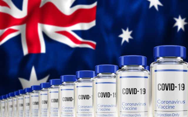 COVID vaccine vials against Australian flag