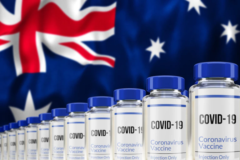 COVID vaccine vials against Australian flag