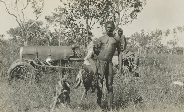 black and white photo of figures in outback