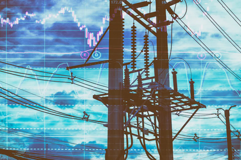 An electricity pole with a stock chart in the background.