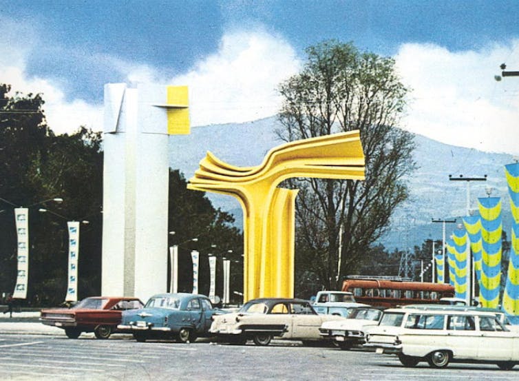 An abstract structure of reinforced concrete, painted yellow, on a Mexican road
