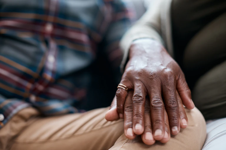 Closeup shot of a mature couple holding hands