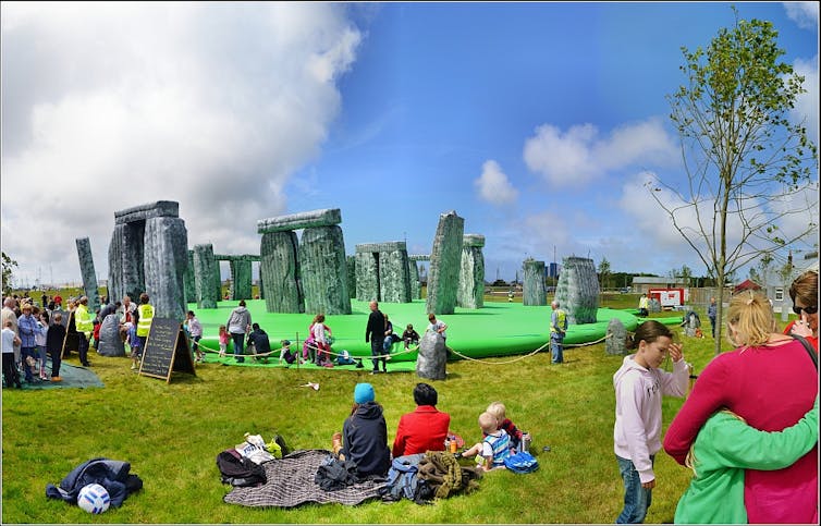 Punters jump on an inflatable Stonehenge art installation