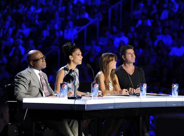 X Factor judges LA Reid, Nicole Scherzinger, Paula Abdul and Simon Cowell seated at the judges table