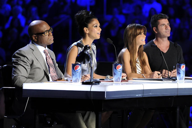 X Factor judges LA Reid, Nicole Scherzinger, Paula Abdul and Simon Cowell seated at the judges table