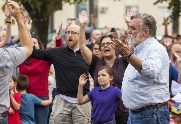 Pastor Douglas Wilson leads others at a protest in Moscow, Idaho.