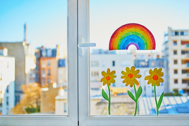 Drawings of flowers and rainbows in a window