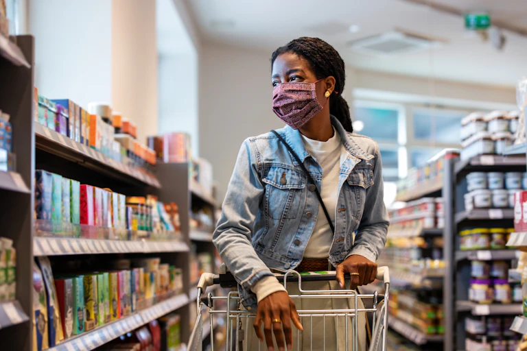 Female shopper with face mask at grocery store