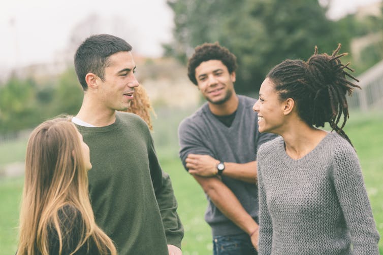 A group of young adults in a park.