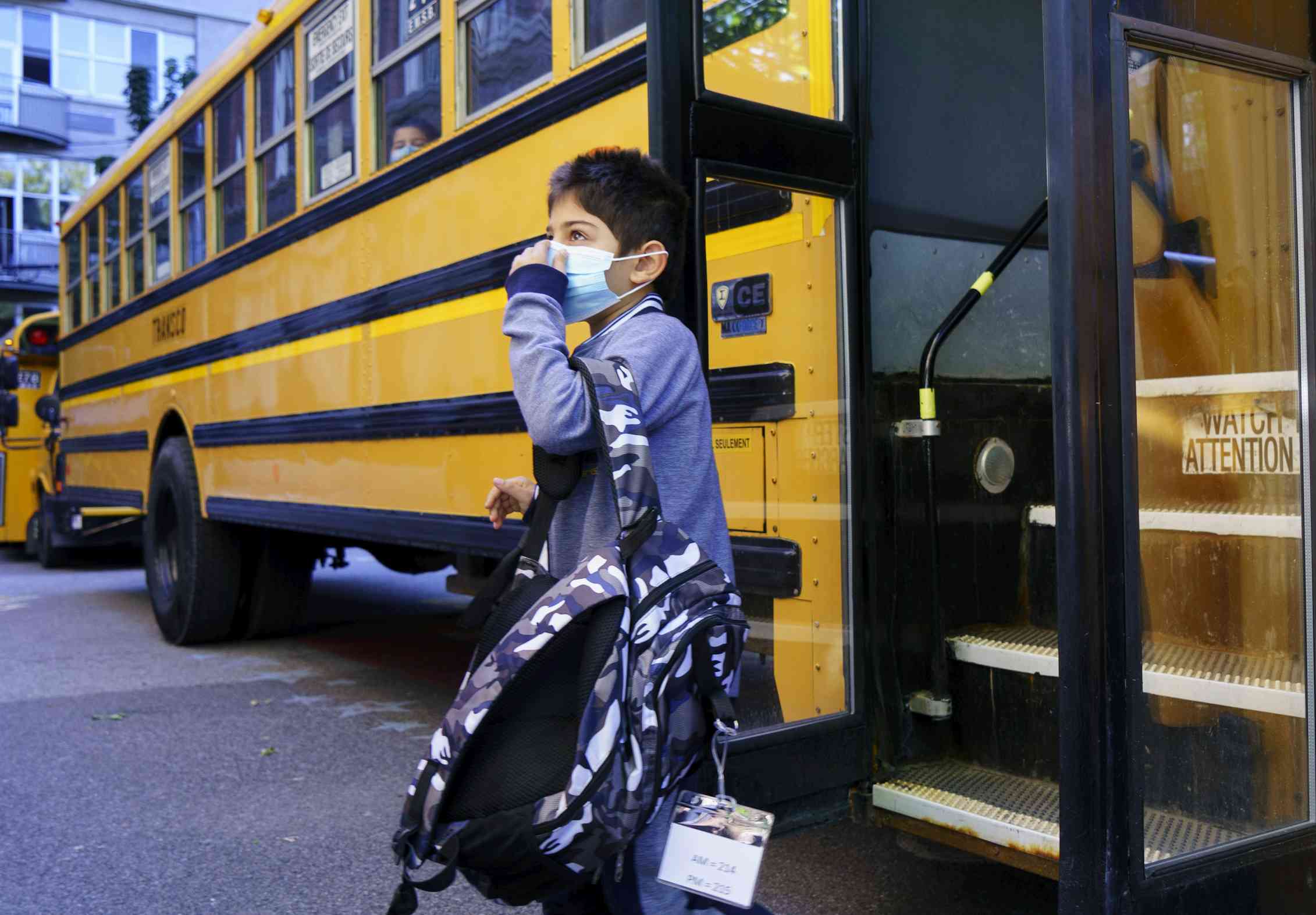 A student steps off a school bus.