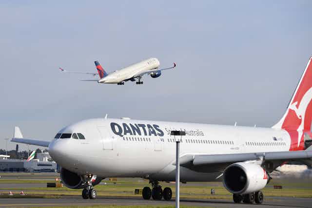 A Delta airlines plane takes to the sky over Sydney airport. 