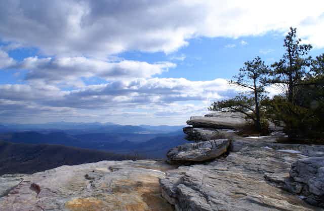 Rock ledge with view of forested mountains