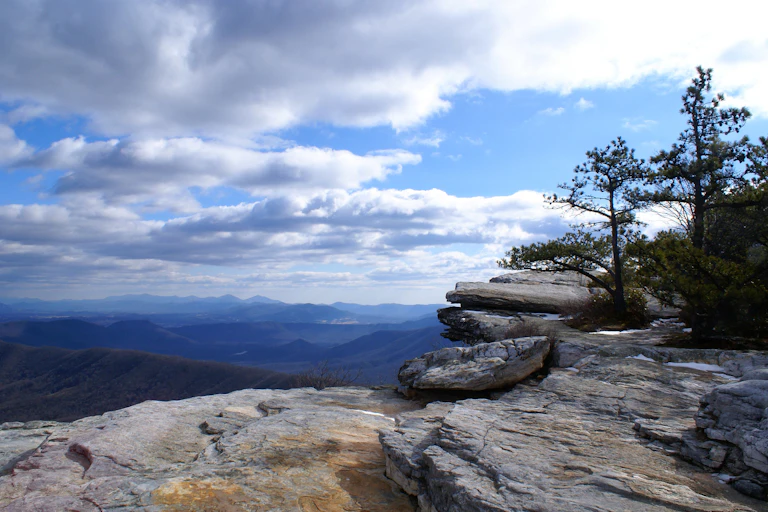 Rock ledge with view of forested mountains