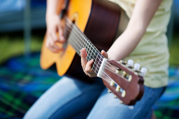Girl playing guitar.