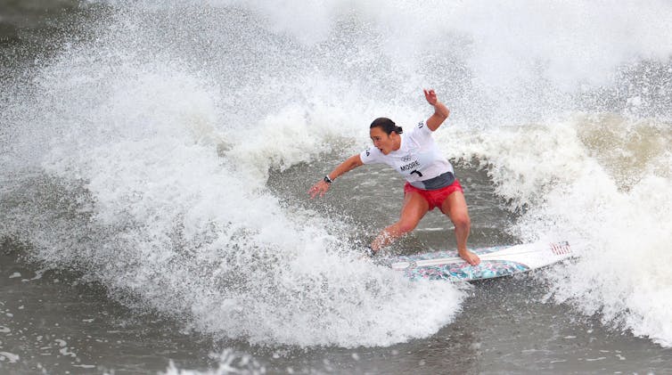 Surfer rides a wave.