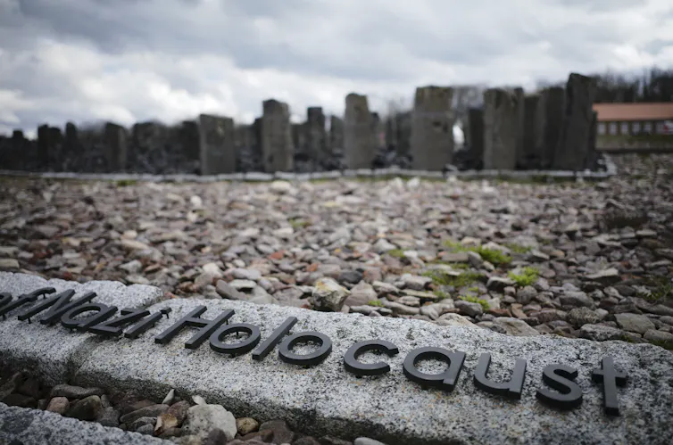 The words 'Nazi Holocaust' on a concrete section of a former Nazi concentration camp.