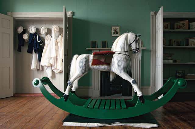 A rocking horse in a Victorian-era playroom 