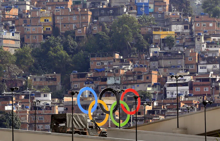 A set of Olympic rings in front of a favela in Rio.