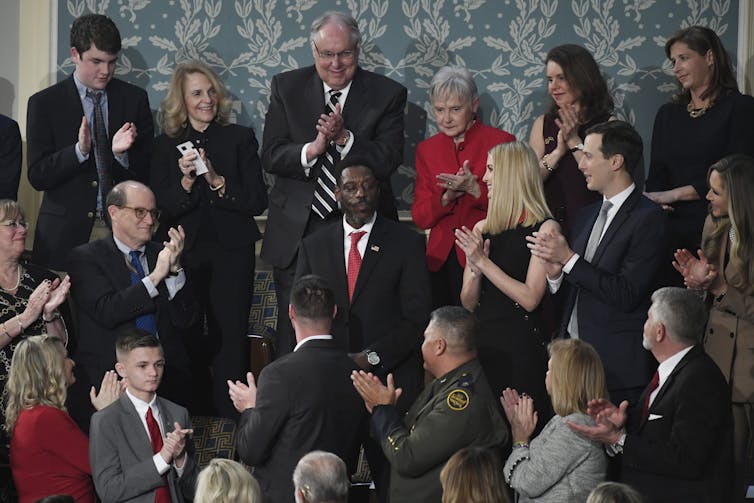 A man receives a standing ovation.