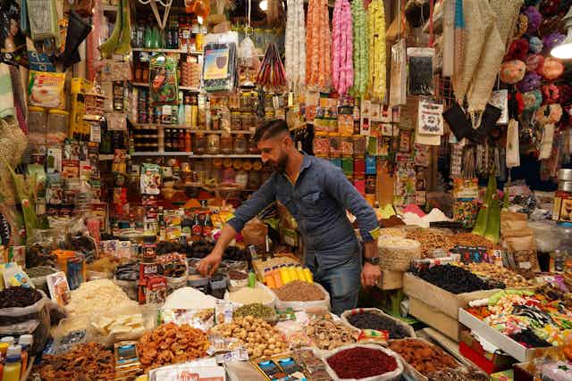 A spice merchant in his shop in Bab Al-Saray market during Ramadan in April 2021