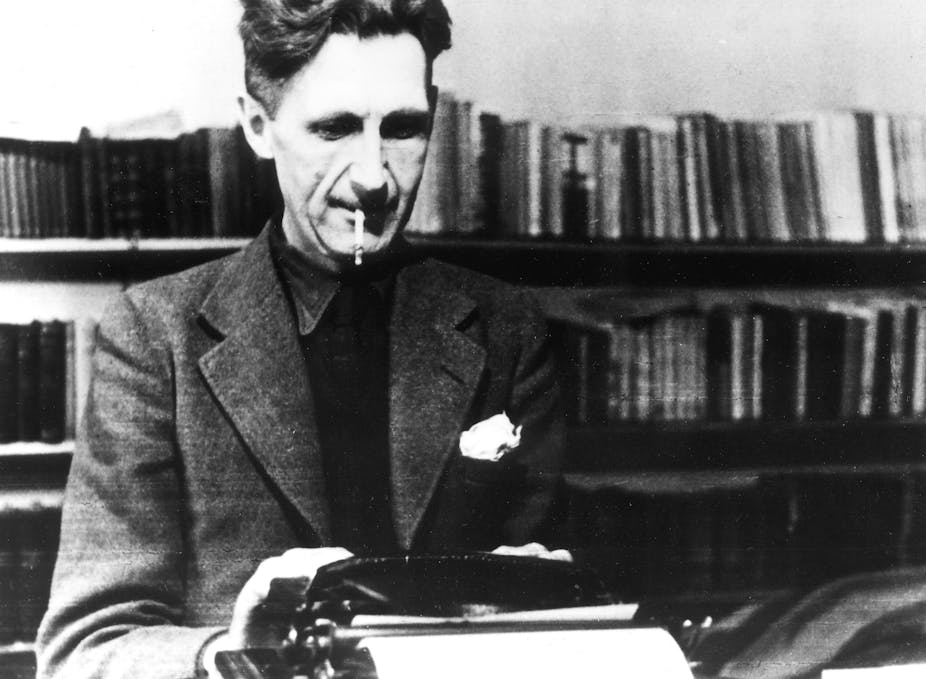 Writer George Orwell working on his typewriter.