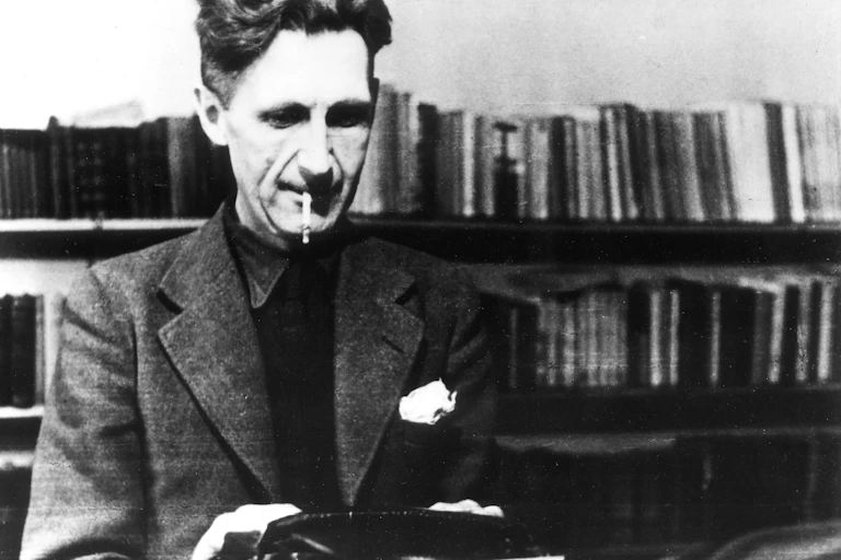 Writer George Orwell working on his typewriter.